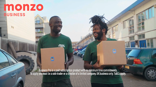 Trap Fruits walking down a street carrying boxes