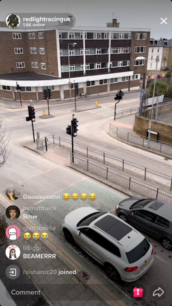 Alt text: Livestream showing two cars waiting at a red light. 