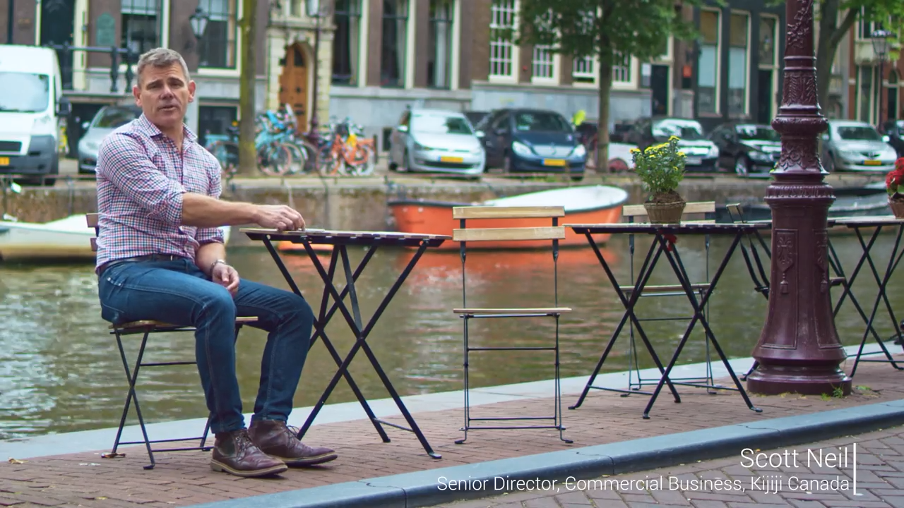 Man sitting at table by canal in Amsterdam