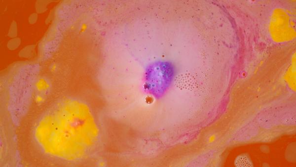 Colourful bath bomb dissolving in water